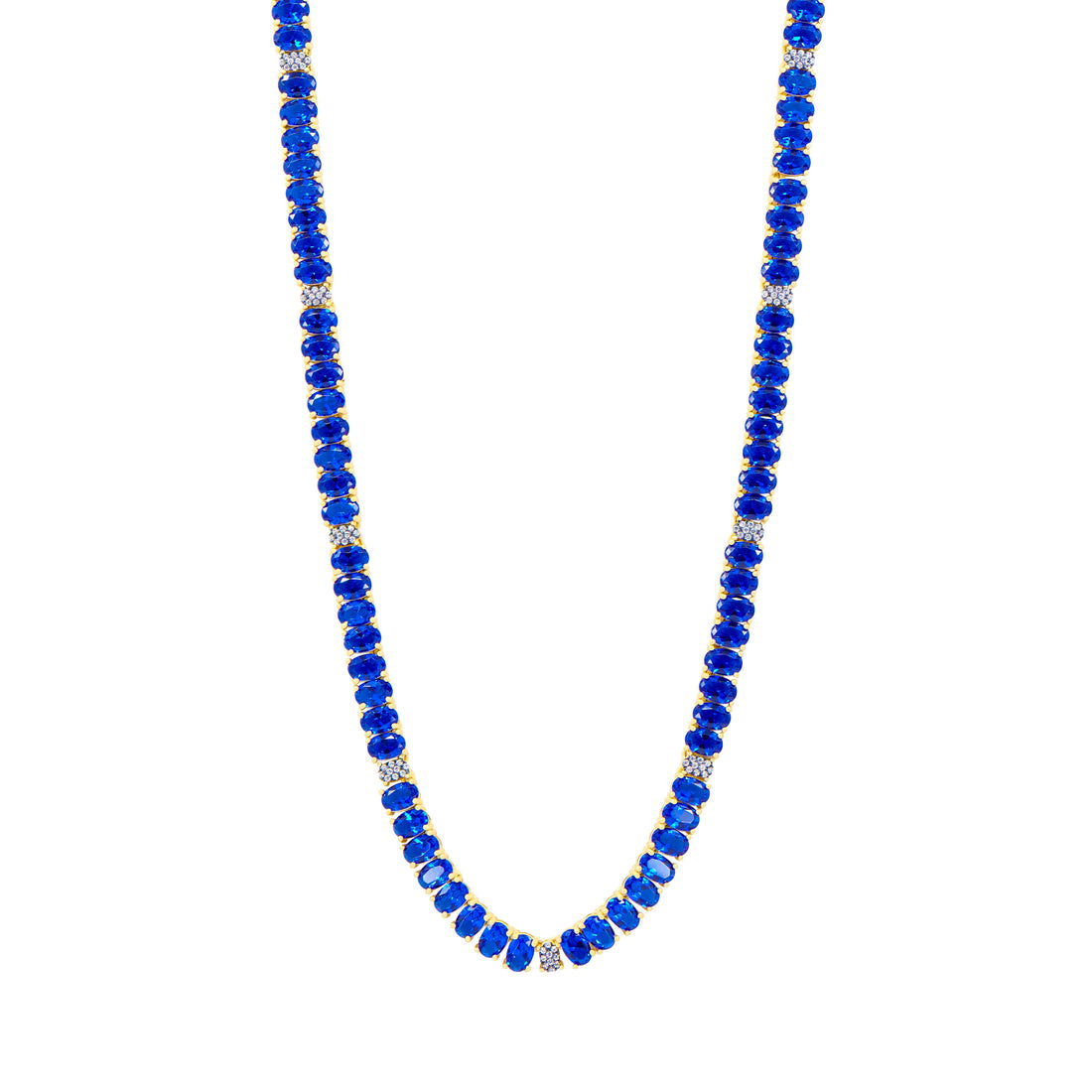 The Midnight Tri-Tone Twilight Oval Station Tennis Necklace, by Midnight, features vibrant blue stones and small silver beads interspersed with 14K matte gold accents. The uniform arrangement exudes a simple yet elegant design, presented against a white background.